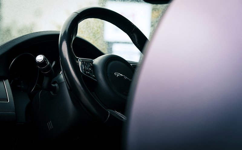 A close up of a steering wheel inside a car